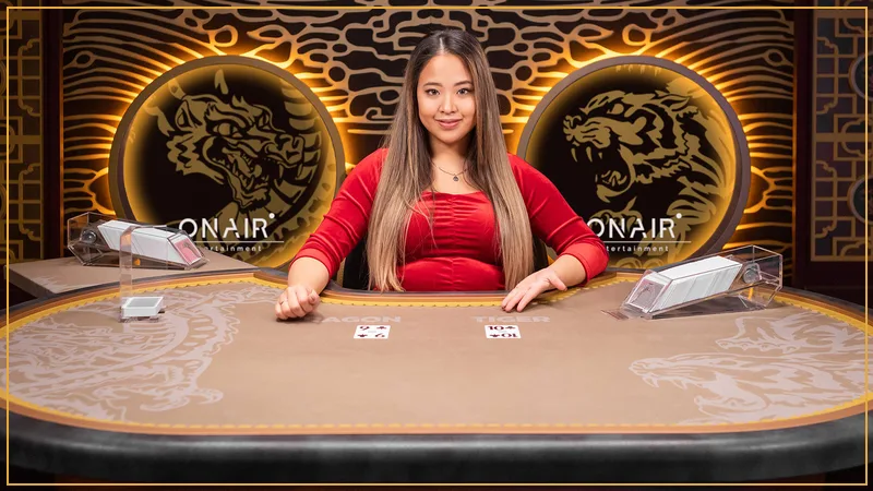 Dragon and Tiger velvet betting boxes with dealt cards and gold chips